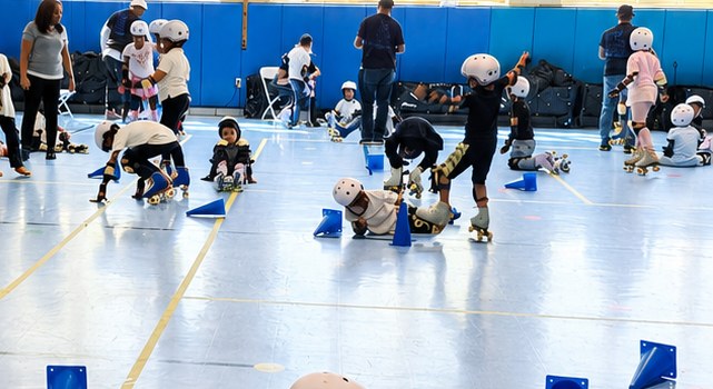 Students actively roller skating through a cone drill in a school gym